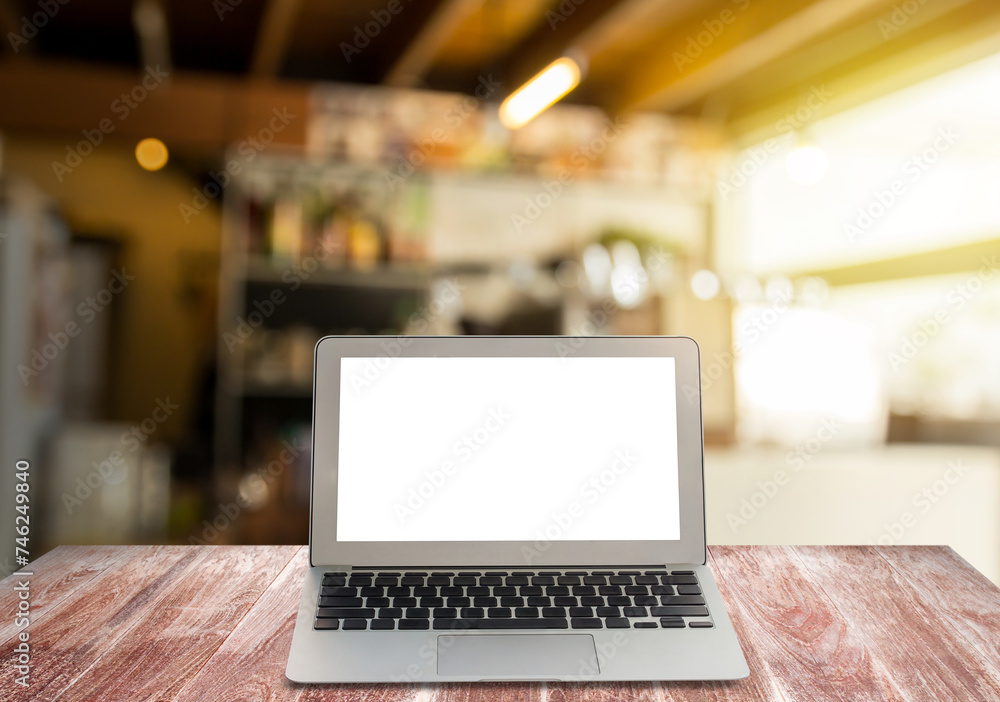 Blank screen laptop on wooden shelves Blank screen laptop on wooden shelves