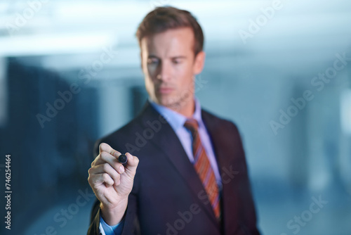 Businessman, planning and writing on glass with pen in office for ideas or strategy for future. Professional, brainstorming and man problem solving on window or screen at night with marker in hand