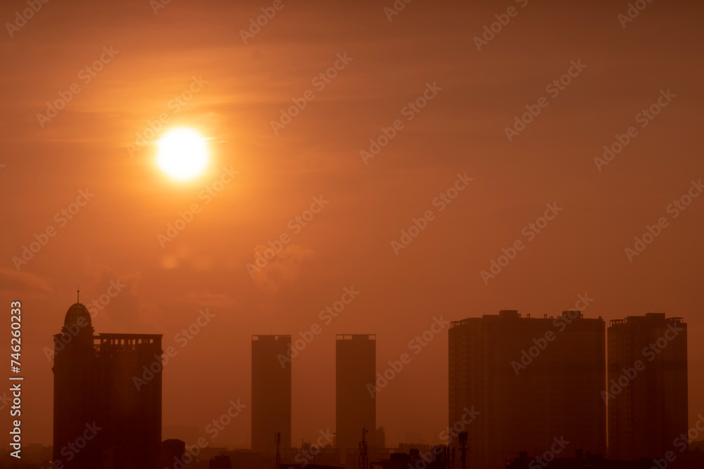 View of cityscape against sky during sunset,Vehicles on road in city against sky. Buildings in city against cloudy sky, Sunset behind the new skyline of china,
High angle view of land during sunset,