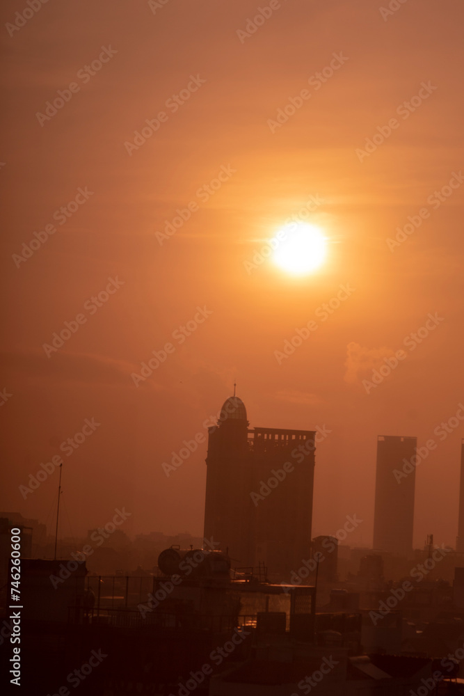 View of cityscape against sky during sunset,Vehicles on road in city against sky. Buildings in city against cloudy sky, Sunset behind the new skyline of china,
High angle view of land during sunset,