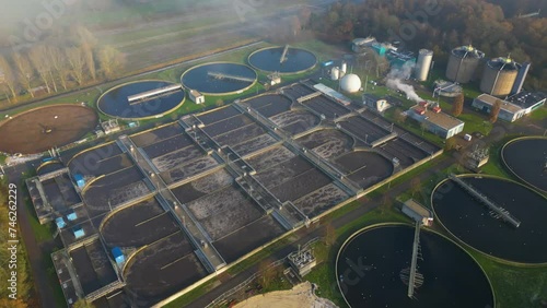 Aerial view orbiting waste water sewage treatment plant sewerage aeriation processing channels photo