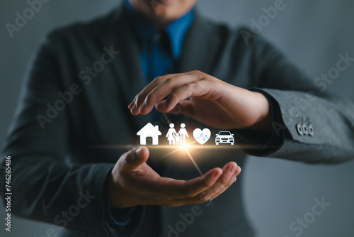 Businessman with protective gesture and car, family, life and health insurance icons. Insurance concept. photo
