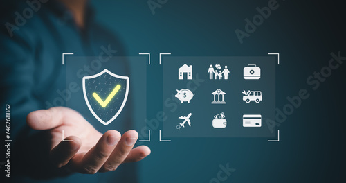 Online insurance and protection plan concept, hand shows insurance icon for house, car, travel, life, family financial, health assurance and retire plan. Protection against a possible eventuality.