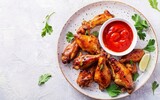 Baked chicken wings in the Asian style and tomatoes sauce on plate