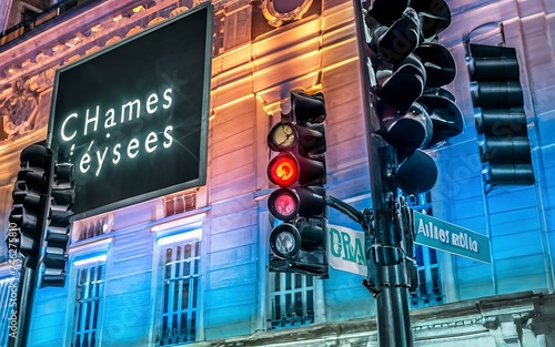 Champ elysees boulevard sign view during night with traffic lights photo