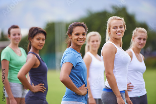 Team, women and friends with sports on field for health, fitness and training with diversity in summer. People, exercise and games in group on grass for workout, wellness or together in Los Angeles