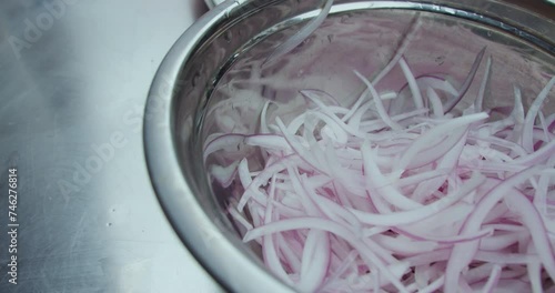 Beautiful closeup detail of a plate with onion cut into strips and washed to be served in sarsa photo