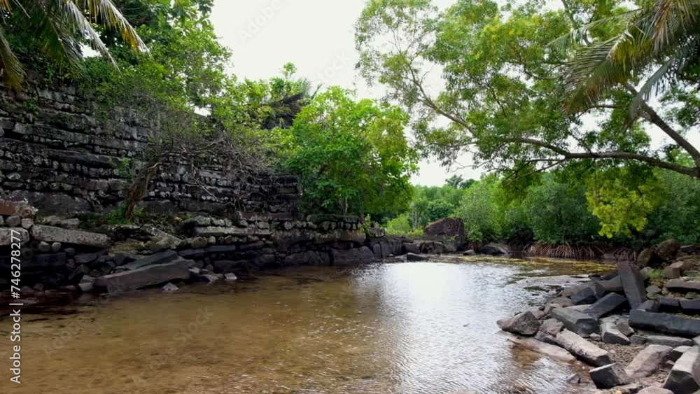 The outer stone walls of the ancient city of Nan Madol surrounded by lagoon canal in Pohnpei, Federated States of Micronesia The outer stone walls of the ancient city of Nan Madol surrounded by lagoon canal in Pohnpei, Federated States of Micronesia