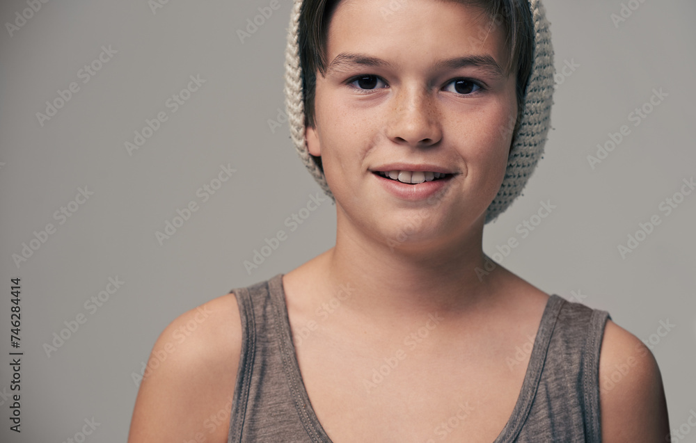 Boy, child and beanie in studio for portrait with smile, teenager or edgy for fashion by background. Kid, model and hat for trendy style, happy and pride for clothes with confidence in hipster outfit Boy, child and beanie in studio for portrait with smile, teenager or edgy for fashion by background. Kid, model and hat for trendy style, happy and pride for clothes with confidence in hipster outfit