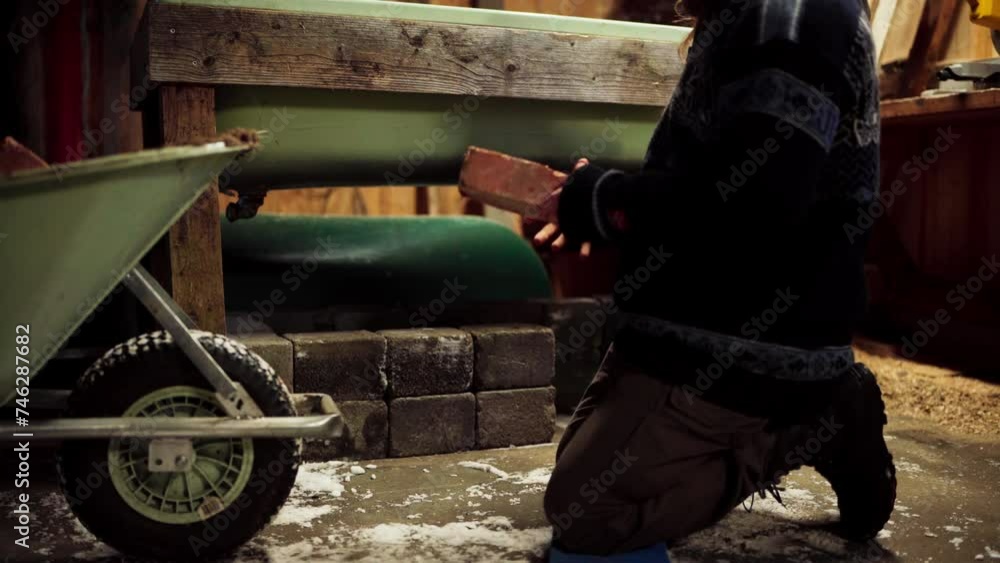 The Man is Placing Bricks Beneath the DIY Hot Tub - Close Up The Man is Placing Bricks Beneath the DIY Hot Tub - Close Up