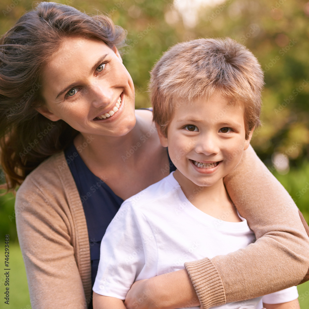 Fototapeta premium Mother, son and hug with park, love and smile with portrait and together for happiness. Woman, child and nature with embrace, bonding and family with care and childhood for parenting in backyard