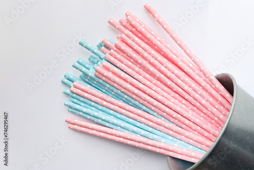 Pink polka dot paper straws and light blue polka dot paper straws on white background. Drinking straws  Eco friendly paper straws concept.