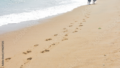 Footprints of humans on the beach.