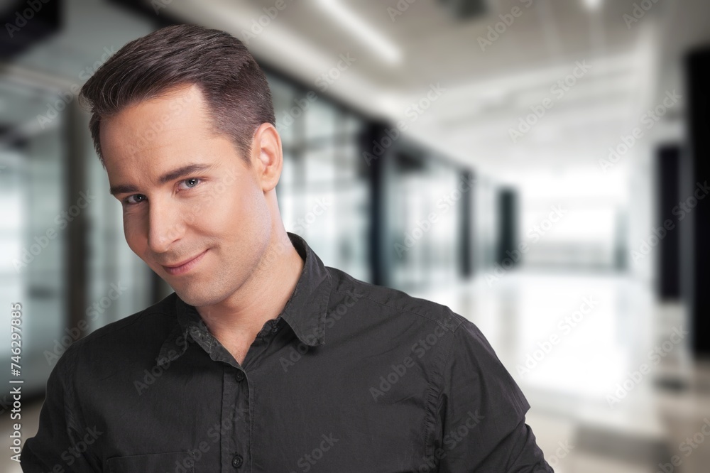 Ambitious handsome male employee posing in office Ambitious handsome male employee posing in office