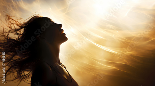 A woman with flowing backlit hair, her hair blowing in the wind, sunburst behind her, backlit face.