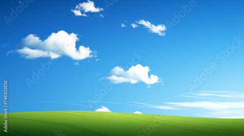 Vibrant landscape with lush green hill covered in grass against bright blue sky, scenic nature view