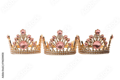 Set of Three Pink and Gold Crowns. Three elegant crowns, one pink and two gold, are displayed. They are positioned side by side, showcasing their regal beauty. On PNG Transparent Clear Background.
