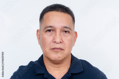 Stoic and serious expression of a middle-aged Asian man, isolated on a clean white backdrop.