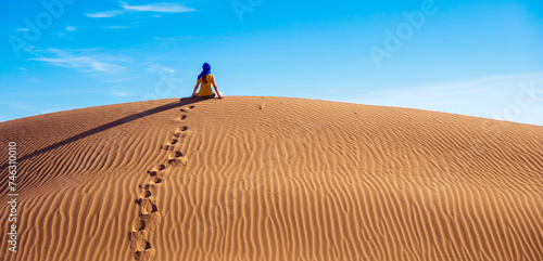 Foot print in desert sand dunes- Wanderlust and vacation concept