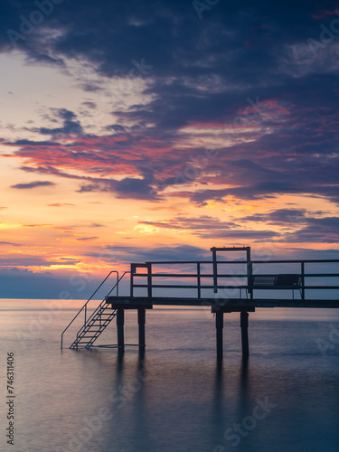 Serene Sunset at a Swedish Pier Jetty Overlooking the Calm Sea