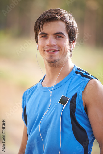 Music player, portrait or or happy man running with earphones in outdoor exercise or fitness workout. Runner, nature or athlete listening to playlist for streaming radio, podcast or sports training