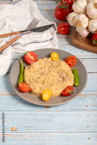 Roasted eggplant salad. Appetizer foods. Eggplant salad on blue wood background photo