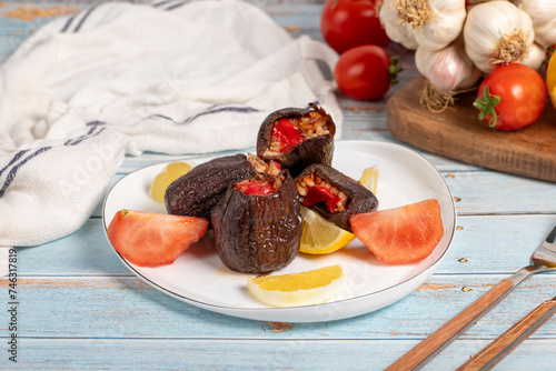 Eggplant stuffed with rice. Appetizer dishes. Stuffed eggplant with olive oil on a blue wooden background. local name patlican dolması photo