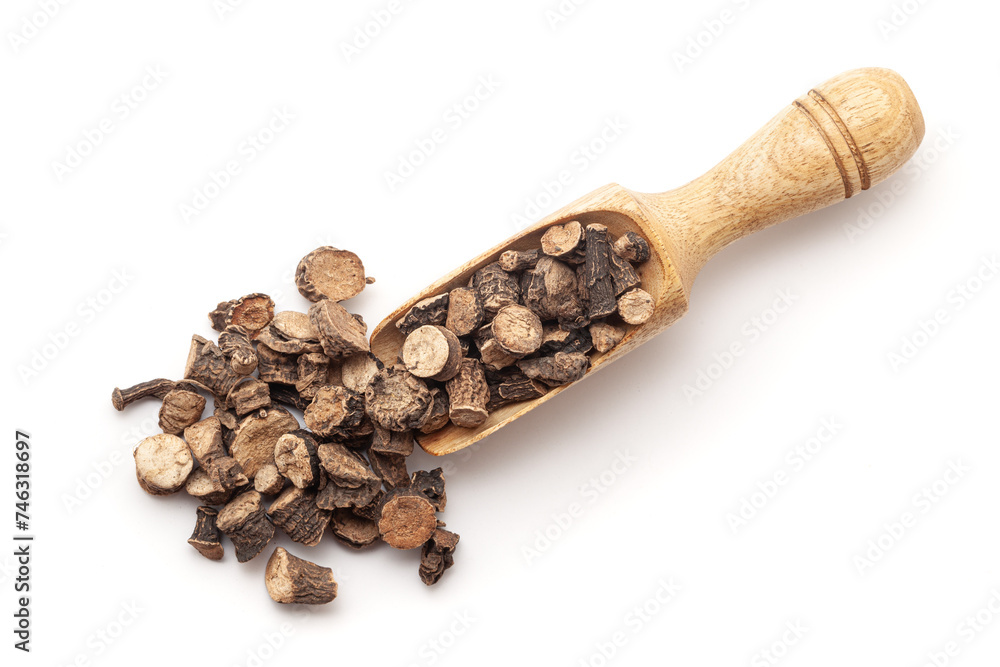 Top view of a wooden scoop filled with Organic Golden eye grass or Black Musli (Curculigo orchioides) herb. Isolated on a white background. Top view of a wooden scoop filled with Organic Golden eye grass or Black Musli (Curculigo orchioides) herb. Isolated on a white background.