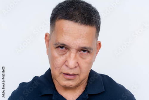 A portrait of an unhappy middle-aged Asian man looking displeased, set against a white background.