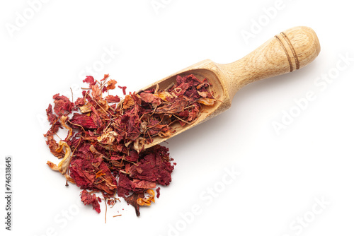 Top view of a wooden scoop filled with Dry Organic Hibiscus (Hibiscus rosa-sinensis) flowers. Isolated on a white background. photo