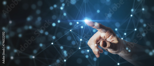 Fotografie A human hand reaching out to touch a point within a complex network of connectio