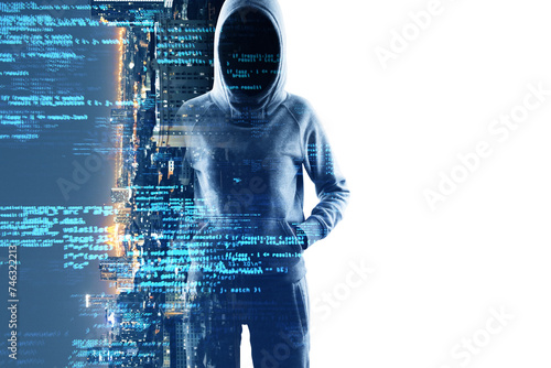 Mysterious cyber hacker with obscured face standing before a screen with futuristic blue digital code signifying cybercrime and security breach photo