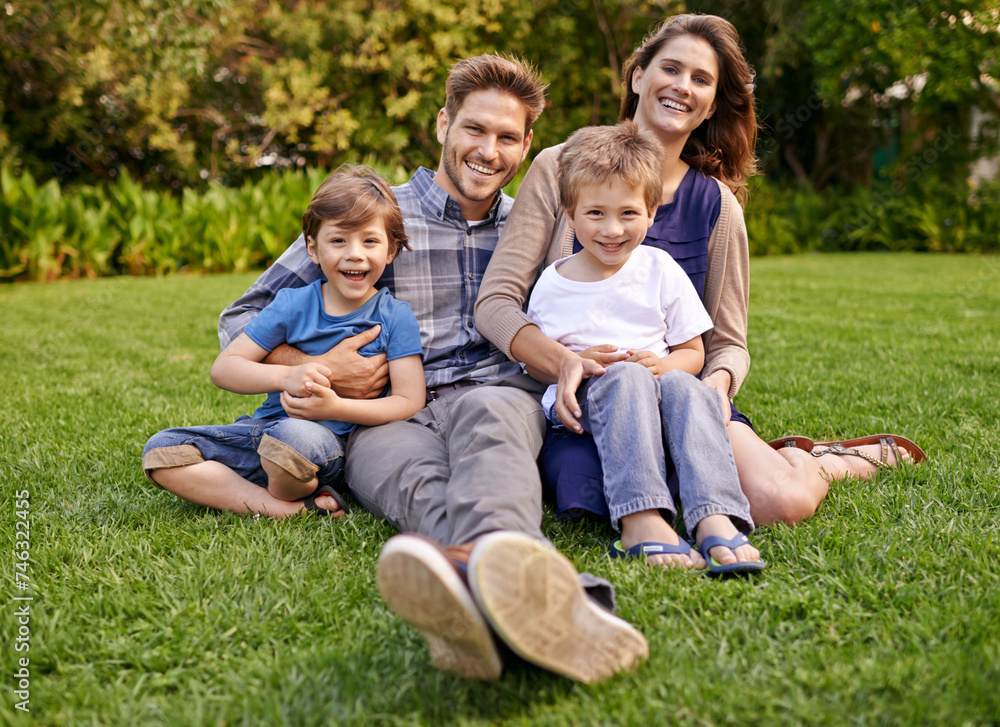 Smile, nature and portrait of children with parents relaxing on grass in outdoor park or garden. Happy, love and boy kids sitting on lawn with mother and father for bonding in field together. Smile, nature and portrait of children with parents relaxing on grass in outdoor park or garden. Happy, love and boy kids sitting on lawn with mother and father for bonding in field together.