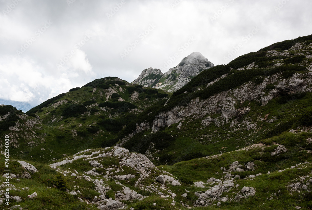 Rolling green hills and granite rock in the Julian Alps Rolling green hills and granite rock in the Julian Alps