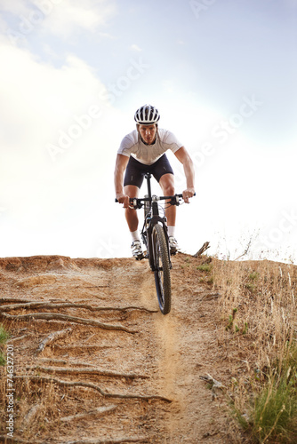 Fototapeta Naklejka Na Ścianę i Meble -  Portrait, bike and man off road cycling on dirt track for sports, competition or outdoor hobby. Fitness, nature and race with confident young athlete or cyclist in helmet for cardio performance