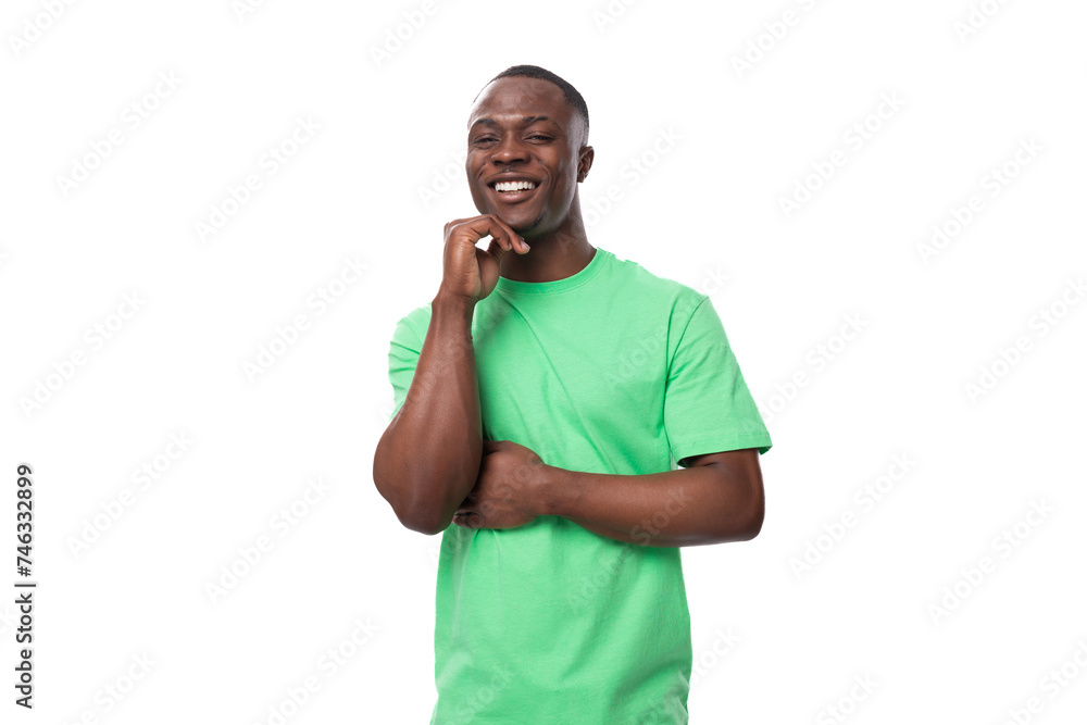 portrait of young smart african man dressed in green t-shirt and jeans isolated on white background portrait of young smart african man dressed in green t-shirt and jeans isolated on white background