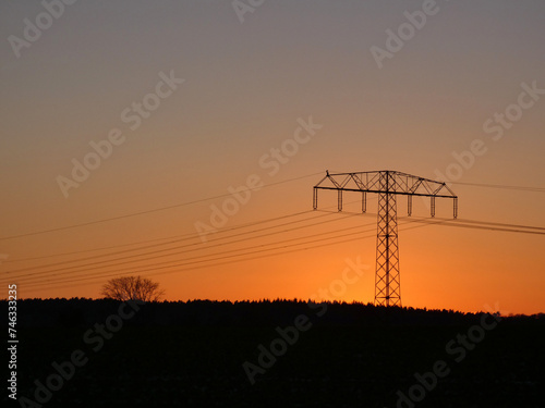Sonnenuntergang mit Hochspannungsmast, Lohmen, Germany photo