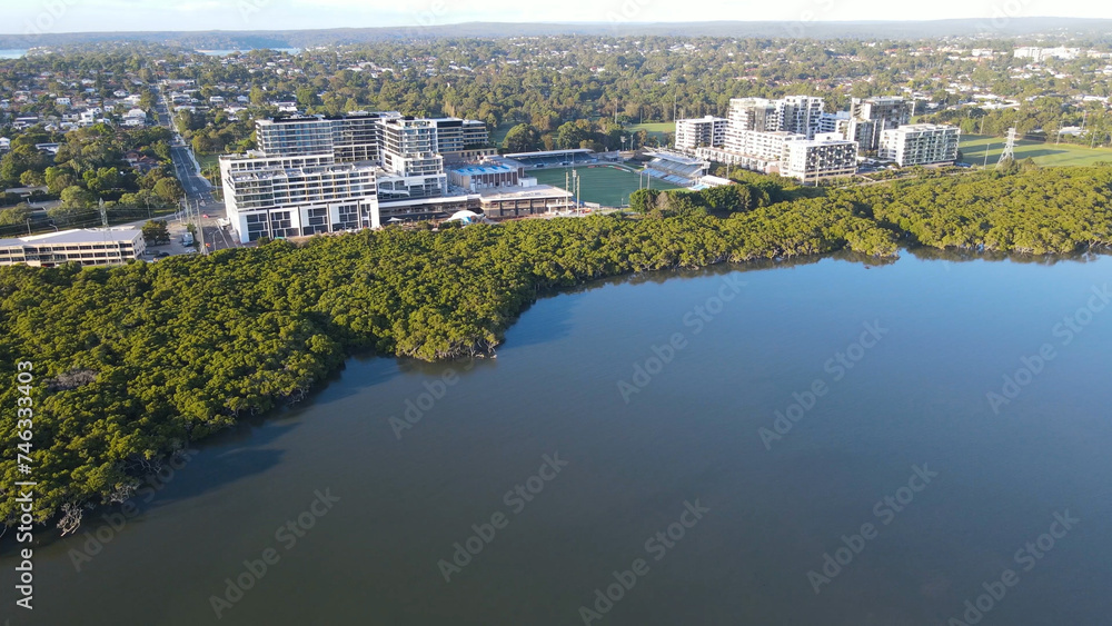 Aerial drone view of residential and retail buildings at Woolooware Bay in the Sutherland Shire, South Sydney, NSW Australia during a sunny morning in February 2024   