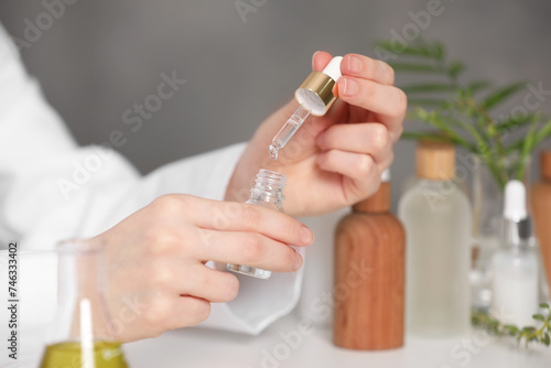 Dermatologist testing essential oil indoors, selective focus