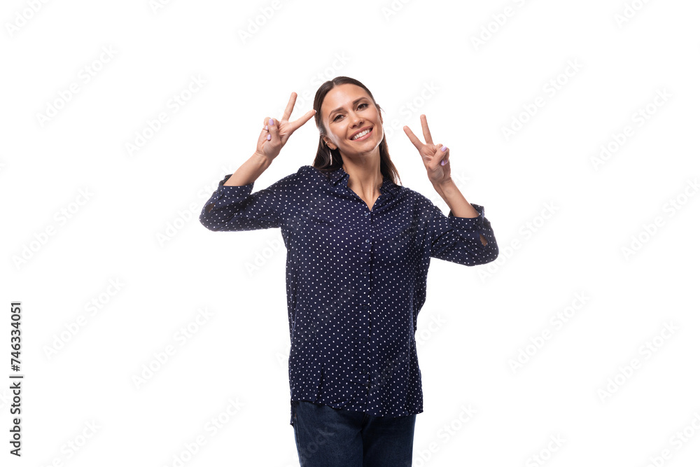 young European slender brunette woman in blue clothes smiles affably young European slender brunette woman in blue clothes smiles affably