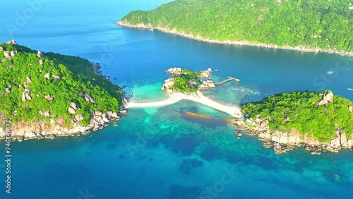 Explore an island chain interconnected by scenic sandbars, inviting you to delve into crystal-clear waters for unparalleled snorkeling and diving adventures. Koh Tao, Southern Thailand. 4K.  
 photo
