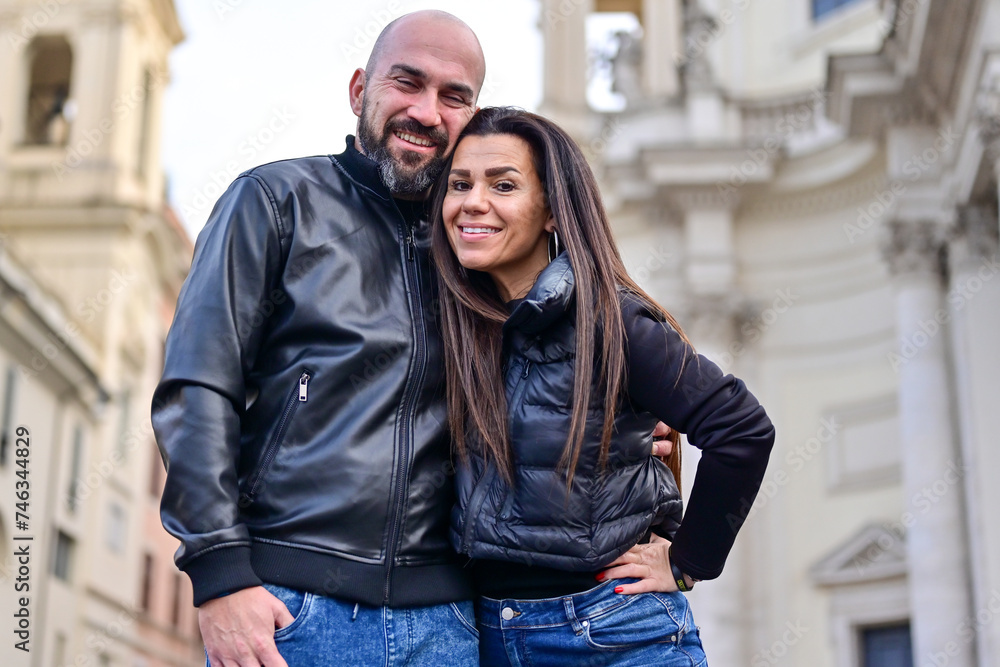 Happy  Beautiful Tourists  couple traveling at Rome, Italy, taking a selfie portrait  at Piazza del Popolo.Visiting Italy - man and woman enjoying weekend vacation - Happy lifestyle concept 