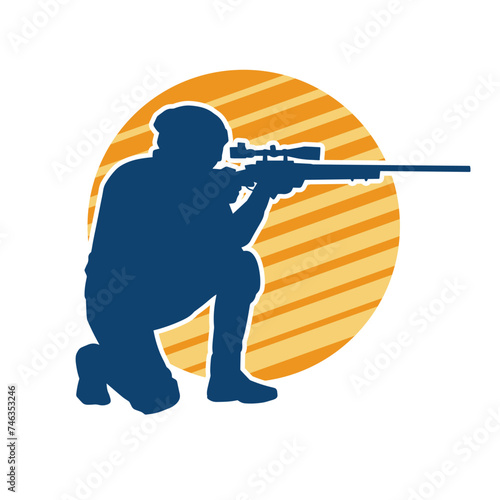 Silhouette of a male shooter firing sniper long barrel riffle gun weapon