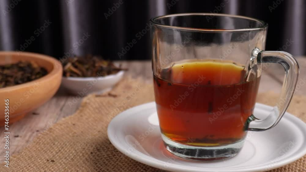 putting down a cup of tea on saucer by hand onto table putting down a cup of tea on saucer by hand onto table