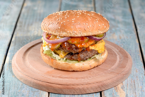 burger on a wooden board