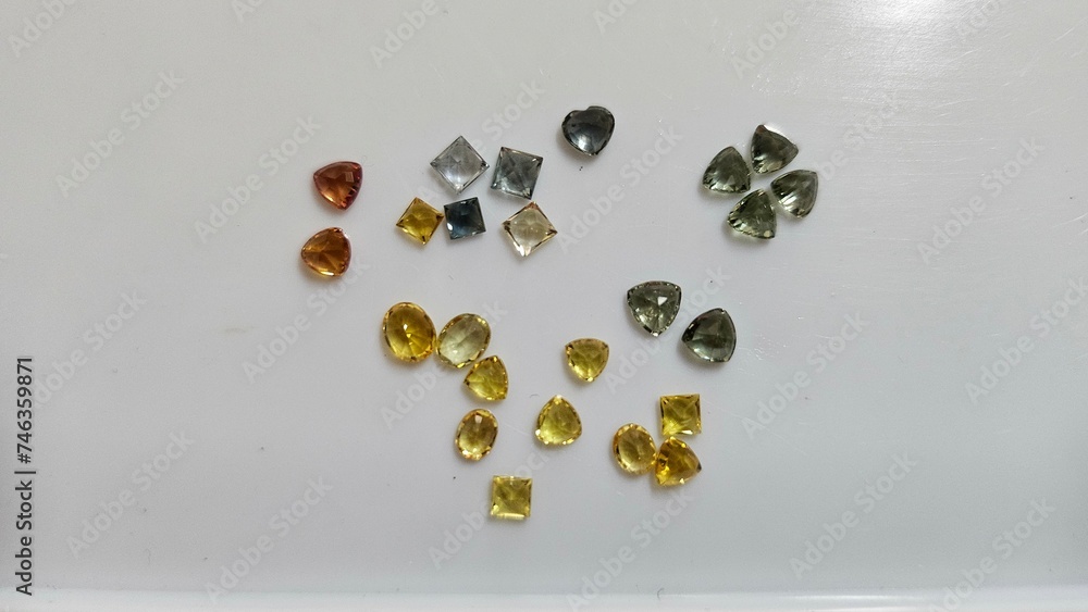 Several color of natural gemstone on white background. Loose gems for sell with flash. Abstract photo
