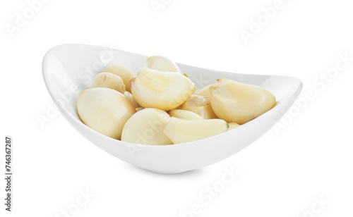 Peeled garlic cloves in bowl isolated on white