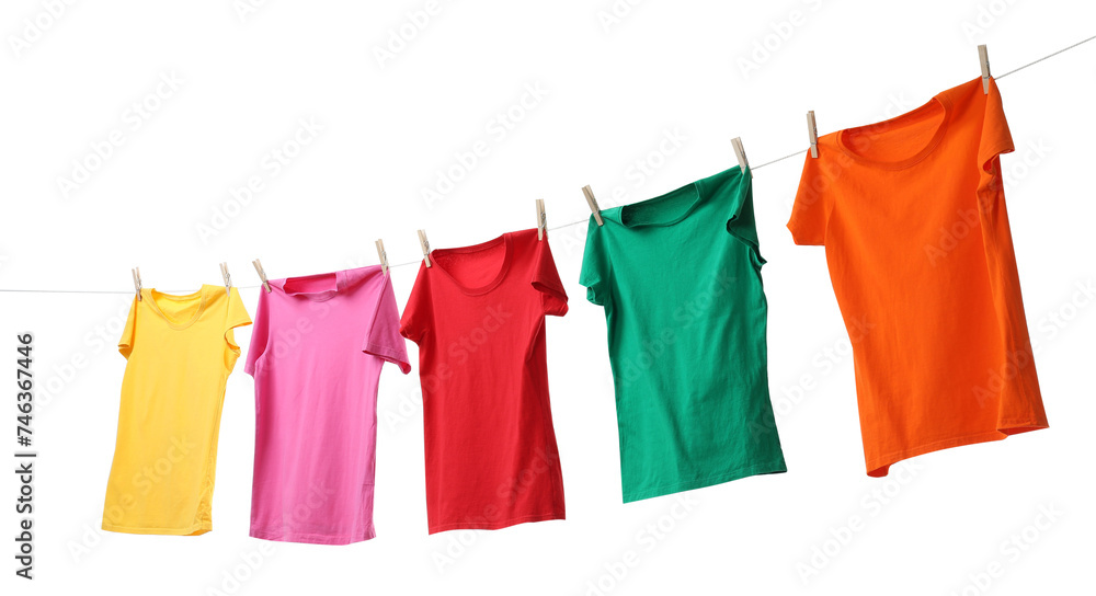 Different bright t-shirts drying on washing line against white background