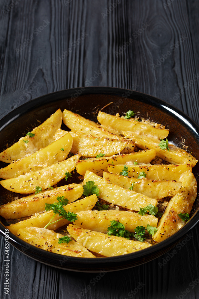 greek lemon potatoes with garlic, cheese on dish greek lemon potatoes with garlic, cheese on dish
