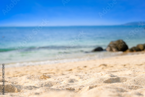 Beach and blue ocean waves for summer vacation concept. Nature of the beach and sea sunny summer The sky is clear. Sandy beach and sparkling sea water